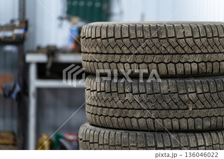 A stack of winter tires in a car repair shop A stack of winter tires in a car repair shop 136046022