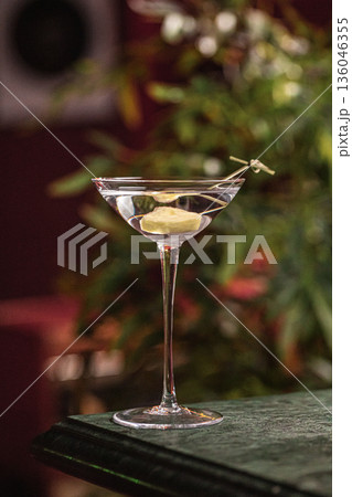 Clear martini cocktail with pineapple garnish Clear martini cocktail with pineapple garnish 136046355