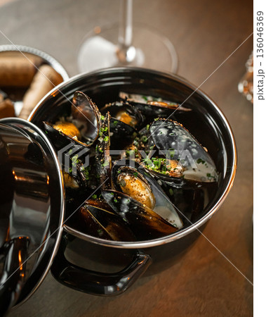 Steamed mussels with herbs in metal pot Steamed mussels with herbs in metal pot 136046369
