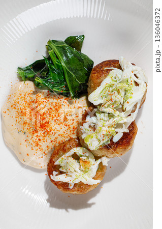 Chicken patties with potato mousse and greens Chicken patties with potato mousse and greens 136046372