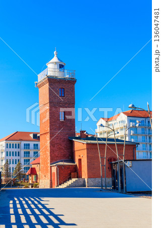 Old brick lighthouse at the Wieprza river mouth to the Baltic Sea in Darlowko, Poland 136047481