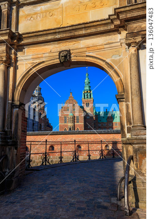 View of Frederiksborg castle through stone arch in Hillerod, Denmark 136047483