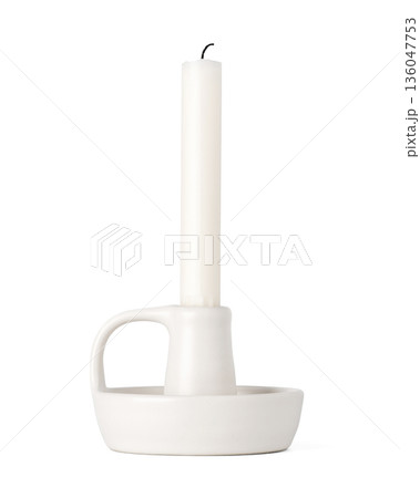 Minimalist white ceramic candle holder with a white wax candle isolated on a white background. home decor and interior design concepts Minimalist white ceramic candle holder with a white wax candle isolated on a white background. home decor and interior design concepts 136047753