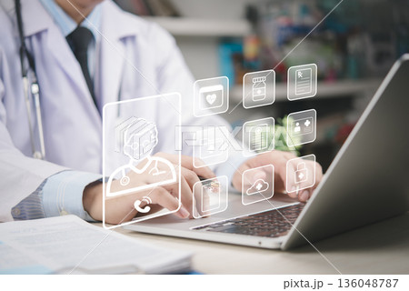 Doctor uses laptop remote care and EHR management, telemedicine consult, patient records, prescription, insurance, diagnosis, data security, healthcare technology, digital health, cloud workflow. 136048787