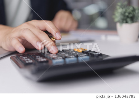 Accountant calculates expenses pressing calculator on office desk, finance budgeting tax audit bookkeeping accuracy business numbers management concept minimal workspace Accountant calculates expenses pressing calculator on office desk, finance budgeting tax audit bookkeeping accuracy business numbers management concept minimal workspace 136048795