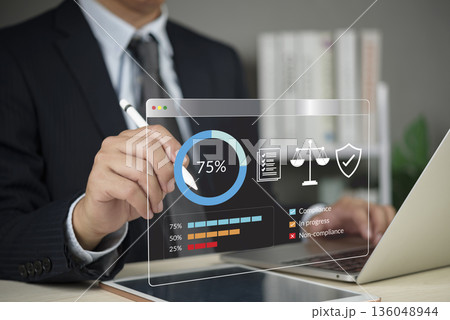 Compliance audit. business professional reviews a dashboard at the office to track governance, risk, regulation, security, data analytics, and certification. concept adherence and trust. 136048944