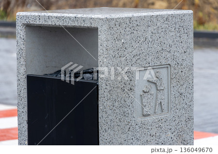 This stylish trash receptacle is located in a bustling urban area, providing a clean solution for waste disposal while enhancing the environment 136049670