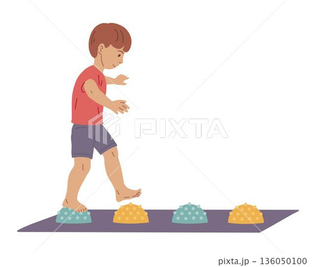 Boy walking on massage mat for foot stimulation 136050100