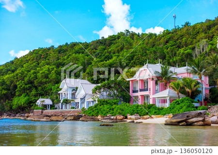 A beautiful beach with a pink house and a white house A beautiful beach with a pink house and a white house 136050120