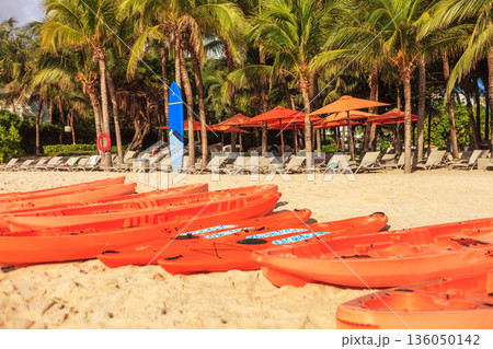Iceland Phu Quoc Vietnam 5.7.2025. A row of orange kayaks are lined up on a sandy beach 136050142