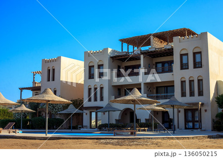 El Gouna Egypt 2.11.2025. A large building with a pool and umbrellas outside 136050215