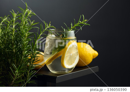 Refreshing drink with ice, lemon slices, and rosemary. Refreshing drink with ice, lemon slices, and rosemary. 136050390