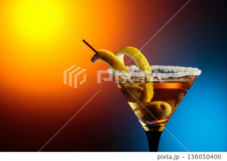 Glass of Martini with green olives and lemon peel. 136050400