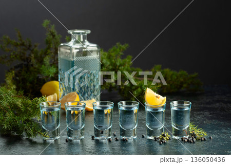 Gin with juniper berries and lemon slices. 136050436