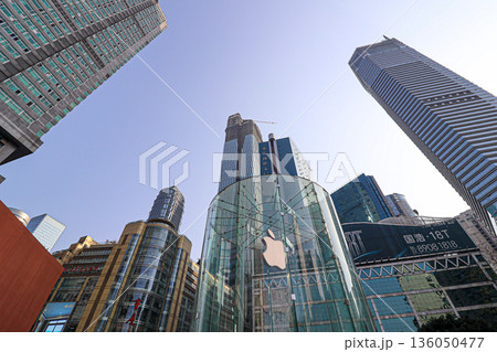 Chongqing China 4.7.2025. A city skyline with a large glass building that has an apple logo on it Chongqing China 4.7.2025. A city skyline with a large glass building that has an apple logo on it 136050477