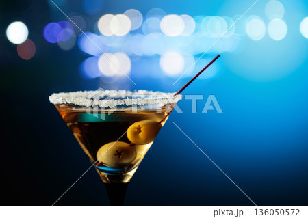 Glass of Martini with green olives. 136050572