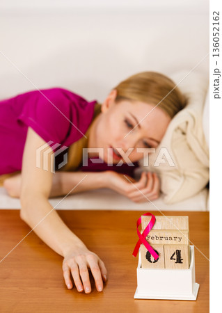 Woman on bed, world breast cancer day on calendar Woman on bed, world breast cancer day on calendar 136052162