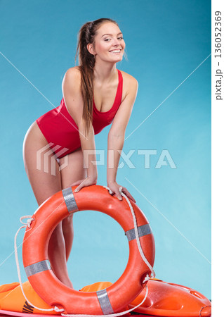 Lifeguard woman on duty with ring buoy lifebuoy. Lifeguard woman on duty with ring buoy lifebuoy. 136052369