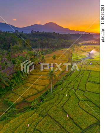 Beautiful morning view in Indonesia, panoramic landscape of rice fields with mountain ranges and clear sky Beautiful morning view in Indonesia, panoramic landscape of rice fields with mountain ranges and clear sky 136052891