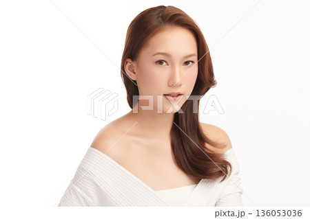 A beautiful young Asian woman with clean, fresh skin against a white background. Skincare, facial treatment, cosmetology, beauty, and spa. An elegant portrait of an Asian woman. 136053036