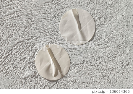 Minimalist aesthetic white round textured wall decor on plaster 136054366