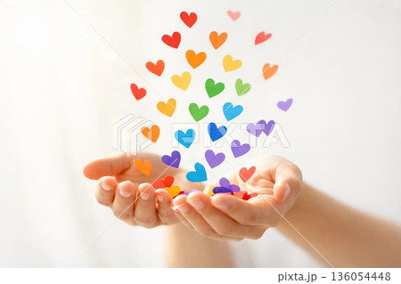Minimal Rainbow Celebration Concept with Hands Releasing Colorful Paper Hearts in Soft Light Minimal Rainbow Celebration Concept with Hands Releasing Colorful Paper Hearts in Soft Light 136054448