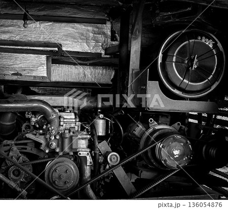 detailed view of a double decker bus engine bay showing belts, pulleys, radiator and hoses. Perfect for automotive maintenance, repair, and mechanical parts themes, conveys industry, repair work, and detailed view of a double decker bus engine bay showing belts, pulleys, radiator and hoses. Perfect for automotive maintenance, repair, and mechanical parts themes, conveys industry, repair work, and 136054876