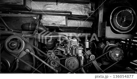 detailed view of a double decker bus engine bay showing belts, pulleys, radiator and hoses. Perfect for automotive maintenance, repair, and mechanical parts themes, conveys industry, repair work, and 136054877