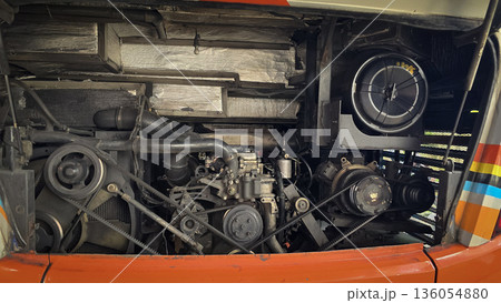 detailed view of a double decker bus engine bay showing belts, pulleys, radiator and hoses. Perfect for automotive maintenance, repair, and mechanical parts themes, conveys industry, repair work, and detailed view of a double decker bus engine bay showing belts, pulleys, radiator and hoses. Perfect for automotive maintenance, repair, and mechanical parts themes, conveys industry, repair work, and 136054880