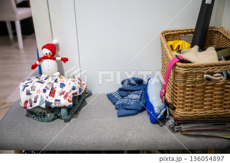 Cozy entryway bench with winter accessories, basket and handmade snowman decor 136054897