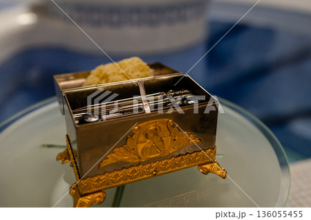 Priest's box with baptism accessories in an Orthodox church, prepared for the sacred ceremony and spiritual tradition Priest's box with baptism accessories in an Orthodox church, prepared for the sacred ceremony and spiritual tradition 136055455