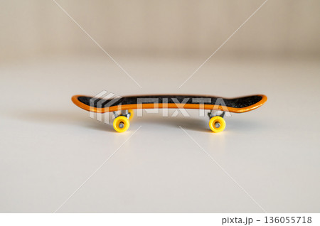children's toy fingerboard on a light background 136055718