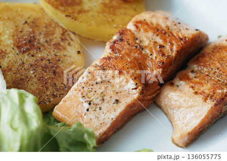 Fresh salmon with grilled vegetables and salad on a plate Fresh salmon with grilled vegetables and salad on a plate 136055775