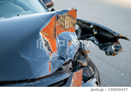 Close-up of damaged car part after accident showing broken metal and scratches 136056437