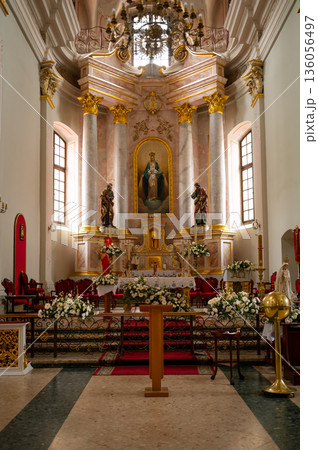altar in catholic cathedral beautifully decorated with flowers 136056497