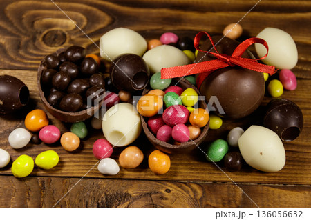 Easter composition with chocolate eggs on wooden background Easter composition with chocolate eggs on wooden background 136056632