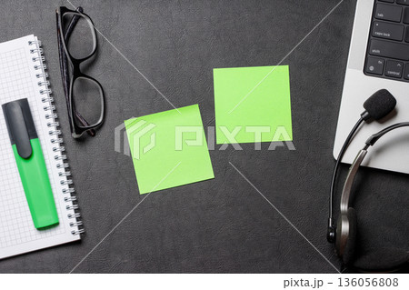 Office supplies and laptop on black leather workspace, top view with copy space 136056808