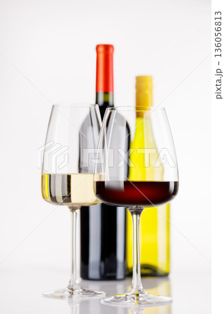 Different wine bottles and glasses on white background Different wine bottles and glasses on white background 136056813