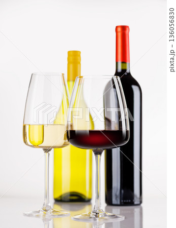 Different wine bottles and glasses on white background 136056830