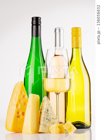 Assorted cheeses and wine on white background Assorted cheeses and wine on white background 136056832