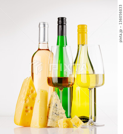 Assorted cheeses and wine on white background 136056833