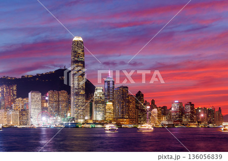 Hong Kong city skyline at sunset with glowing sky and skyscrapers 136056839