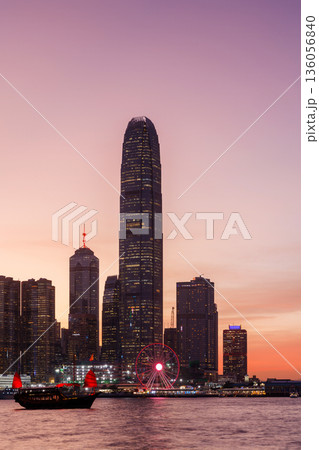 Hong Kong city skyline at sunset with glowing sky and skyscrapers Hong Kong city skyline at sunset with glowing sky and skyscrapers 136056840