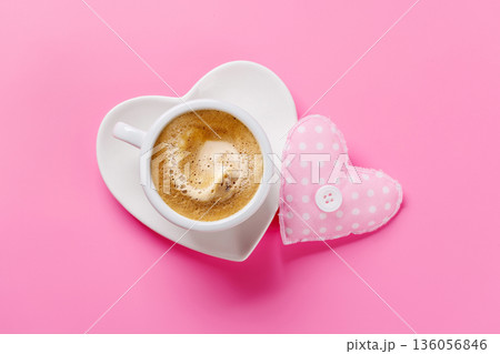 Heart-shaped cappuccino cup on pink background 136056846