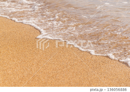 Sunny beach in Hawaii with golden sand, clear water under a bright sky 136056886