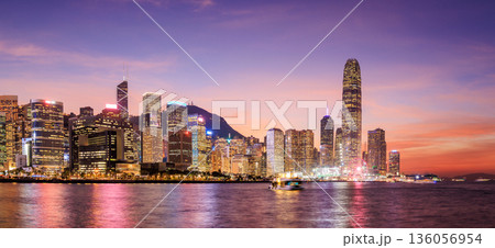 Hong Kong city skyline at sunset with glowing sky and skyscrapers Hong Kong city skyline at sunset with glowing sky and skyscrapers 136056954