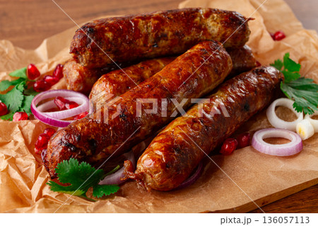 fried kupaty on parchment, with red onion and pomegranate, kupaty, Georgian cuisine, 136057113