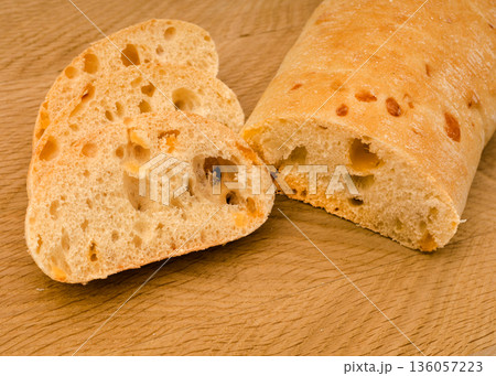 Ciabatta - Italian bread with cheese cut into slices on a wooden board Ciabatta - Italian bread with cheese cut into slices on a wooden board 136057223