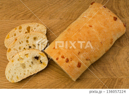 Ciabatta - Italian bread with cheese cut into slices on a wooden board Ciabatta - Italian bread with cheese cut into slices on a wooden board 136057224