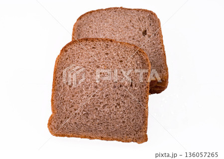 sliced slices of dark bread from a mixture of wheat and rye flour on a white background sliced slices of dark bread from a mixture of wheat and rye flour on a white background 136057265